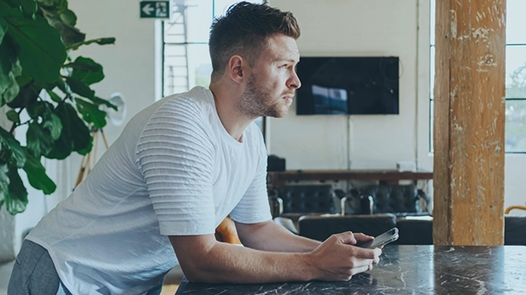 Business professional using mobile phone with Three 5G network