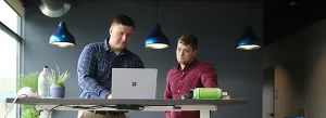 men looking at a laptop 